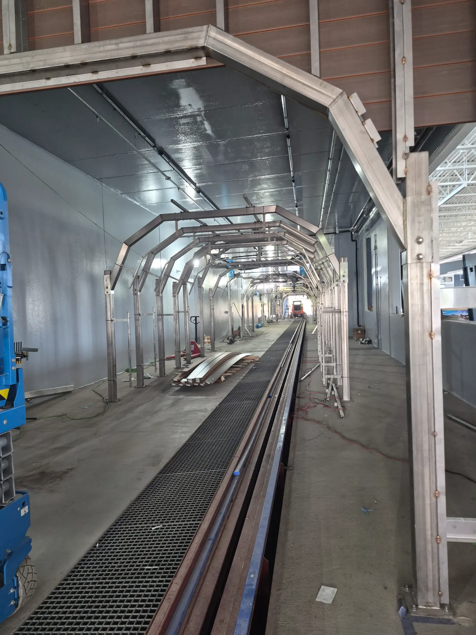 Stainless wash arch frames along the conveyor